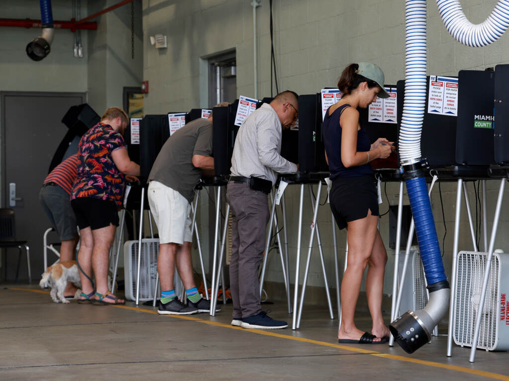 People cast votes at a fire station.