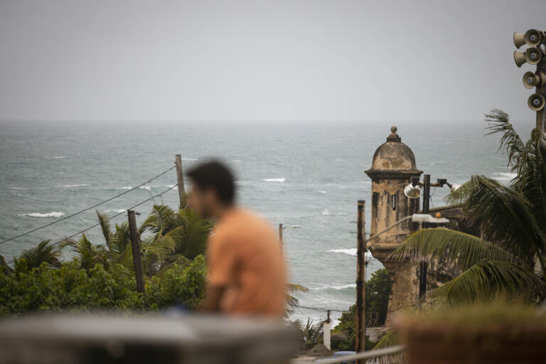 A man stands in front of a beach before the arrival of Tropical Storm Fiona in San Juan, Puerto Rico, Saturday, Sept. 17, 2022. Fiona was expected to become a hurricane as it neared Puerto Rico on Saturday, threatening to dump up to 20 inches (51 centimeters) of rain as people braced for potential landslides, severe flooding and power outages. (AP Photo/Alejandro Granadillo)