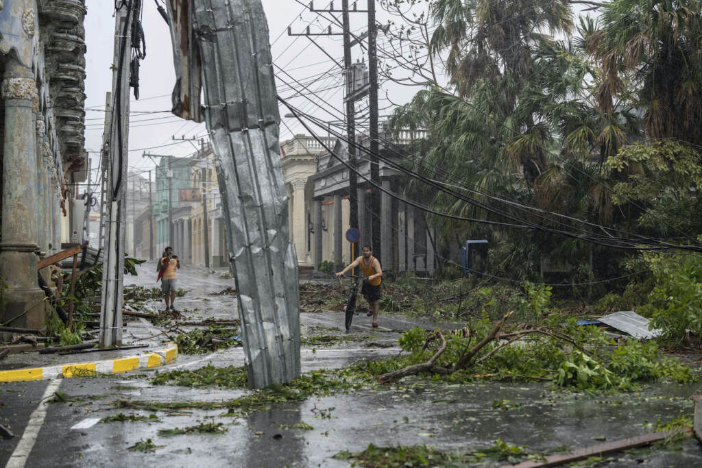 Cuba Tropical Weather Fallen electricity lines, metal and tree branches litter a street after Hurricane Ian hit Pinar del Rio, Cuba, Tuesday, Sept. 27, 2022. Ian made landfall at 4:30 a.m. EDT Tuesday in Cuba’s Pinar del Rio province, where officials set up shelters, evacuated people, rushed in emergency personnel and took steps to protect crops in the nation’s main tobacco-growing region. (AP Photo/Ramon Espinosa)