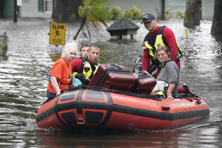 Residents are rescued from floodwaters in the aftermath of Hurricane Ian in Orlando