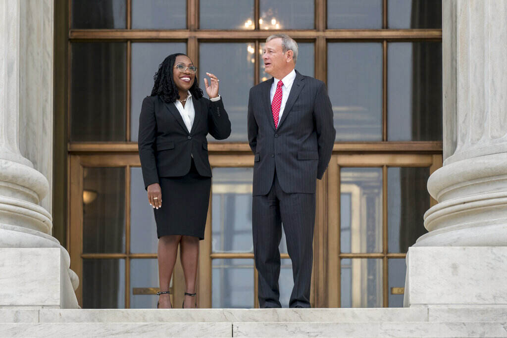 Ketanji Brown Jackson, John Roberts Justice Jackson stands to the left of Justice Roberts outside of a building.