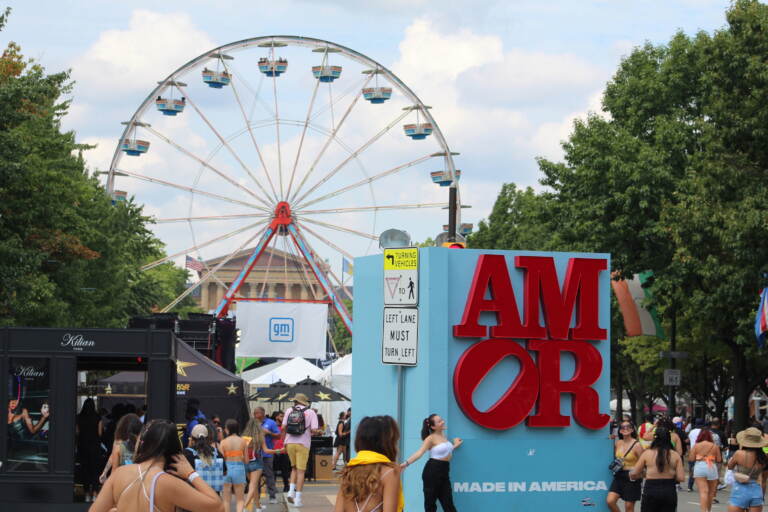 People surround a sign that reads 
