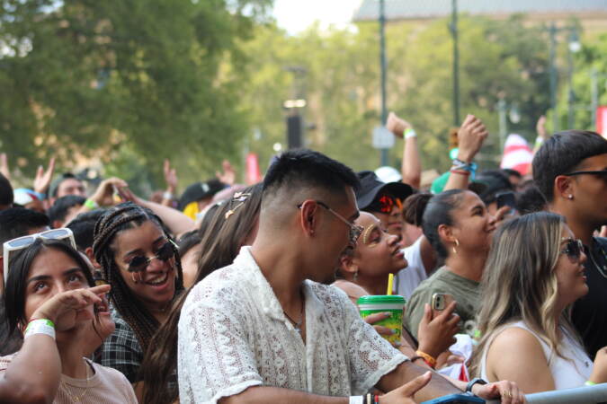 A crowd gathers at a guardrail.