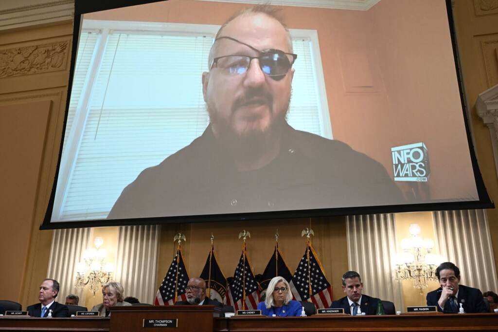 US-POLITICS-CAPITOL-UNREST A person appears on a screen above the Jan. 6 commission members who are seated at a table.