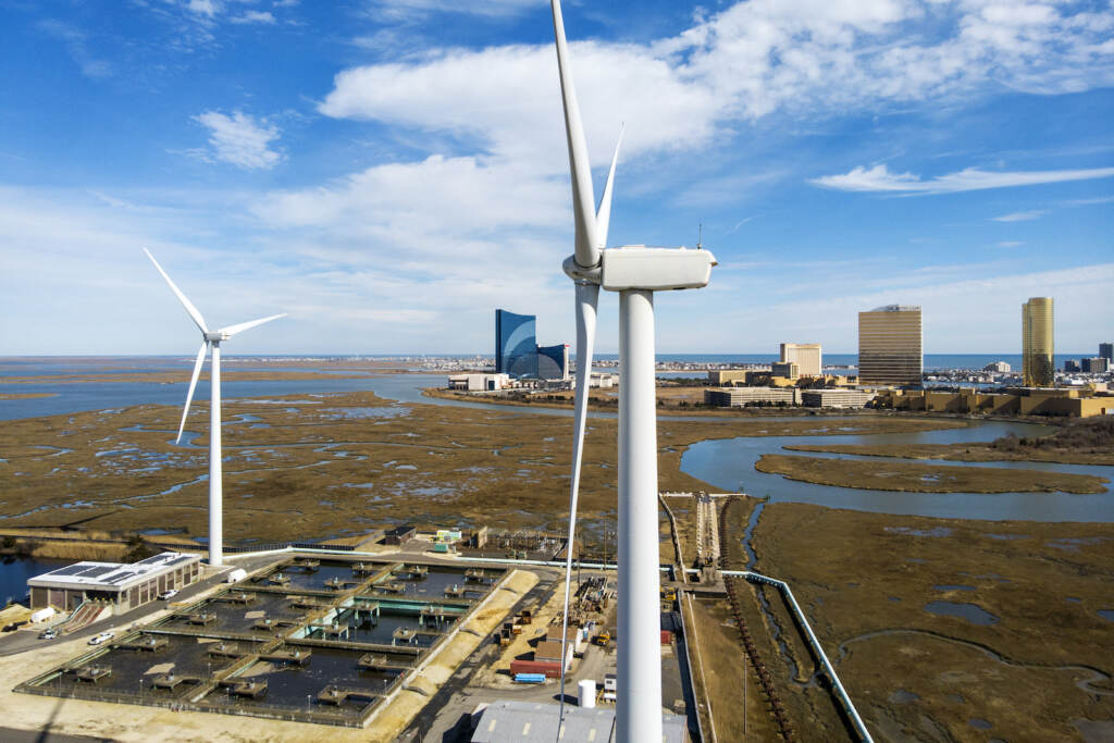 Offshore Wind Equipment Investment Wind turbines spin to generate electrical power in Atlantic City