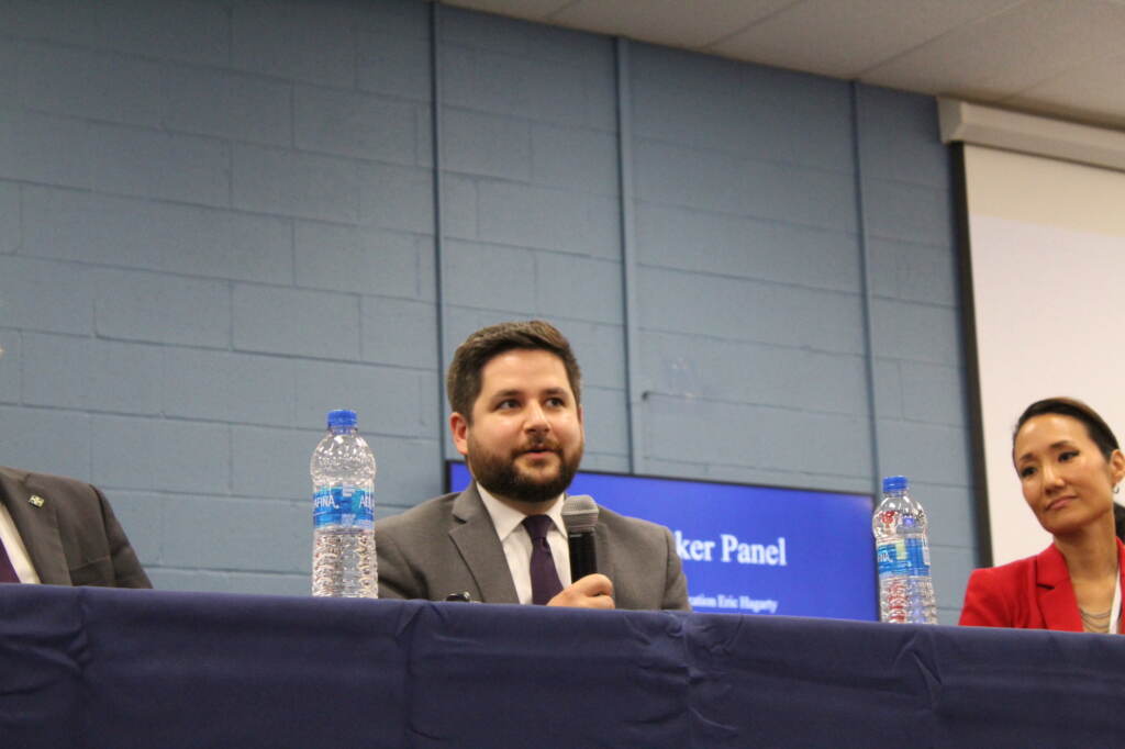 A man speaks into a microphone.