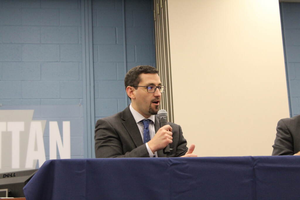 A man speaks into a microphone.