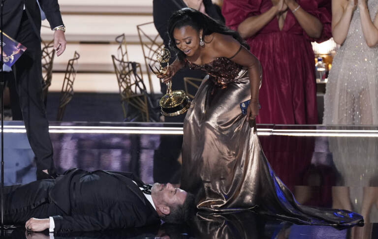 Quinta Brunson checks on Jimmy Kimmel as he lays on stage at the 74th Primetime Emmy Awards