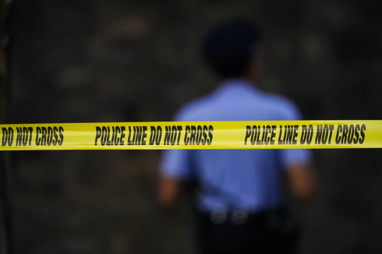 Tape cordons off the area around the scene where multiple people were shot near a high school in Philadelphia