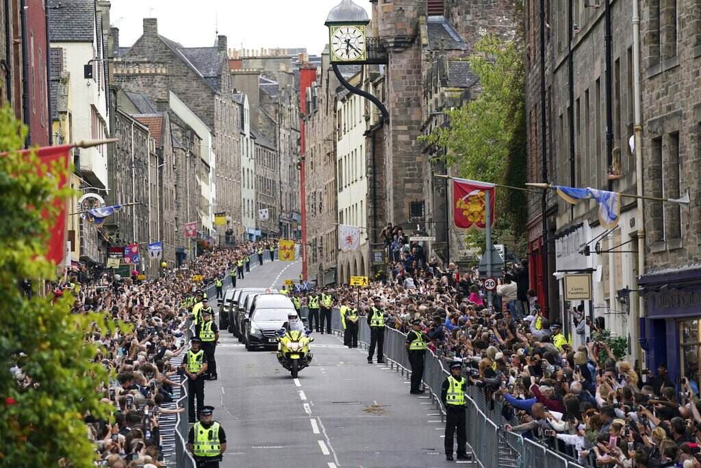 Britian Royals A hearse makes its way through the street in Scotland, which is lined with people on either side.