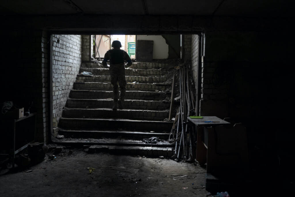 Russia Ukraine War An Ukrainian serviceman walks out of a basement which, according to Ukrainian authorities, was used as a torture cell during the Russian occupation, in the retaken village of Kozacha Lopan, Ukraine, Saturday, Sept. 17, 2022. (AP Photo/Leo Correa)