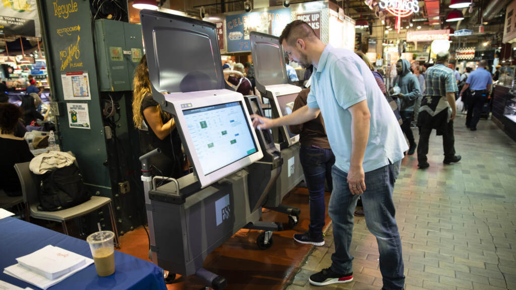 A City Commissioners staffer demonstrates the ExpressVote XL voting machine at Reading Terminal Market in 2019. (AP Photo/Matt Rourke, File)