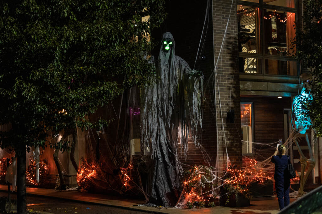 Towering figures are seen in a Halloween display outside a Graduate Hospital building