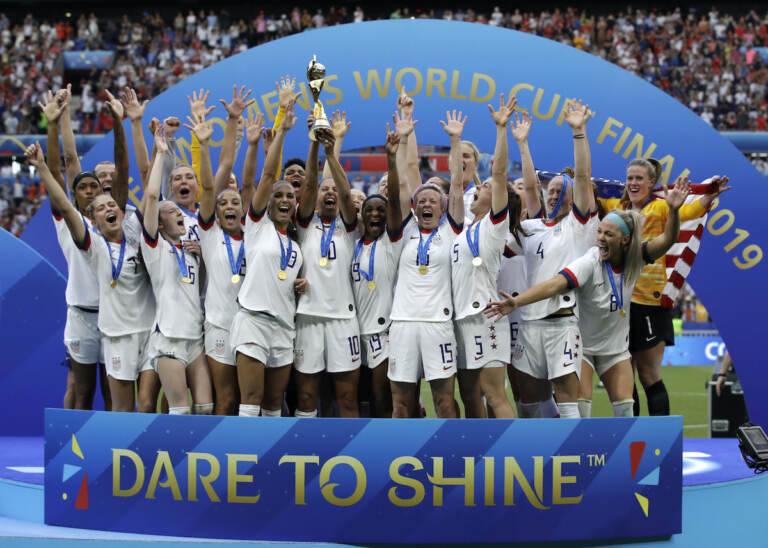 File photo: The United States' team celebrate with the trophy after winning the Women's World Cup final soccer match between against Netherlands at the Stade de Lyon in Decines, outside Lyon, France. As the nation celebrates the 50th anniversary of Title IX, a new poll finds Americans are split on how much progress has come from the landmark women's rights law. (AP Photo/Alessandra Tarantino, File)