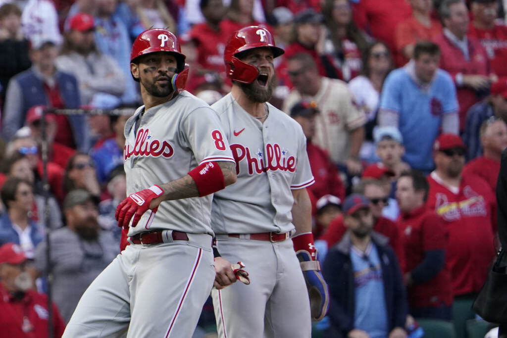 Phillies Cardinals Baseball Philadelphia Phillies' Nick Castellanos (8) and Bryce Harper (3) celebrate after scoring on a single by Jean Segura during the ninth inning in Game 1 of a National League wild-card baseball playoff series against the St. Louis Cardinals, Friday, Oct. 7, 2022, in St. Louis. (AP Photo/Jeff Roberson)