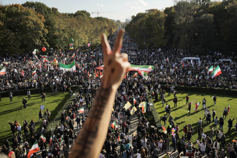A man gestures as people attend a protest against the Iranian regime, in Berlin, Germany, Saturday, Oct. 22, 2022, following the death of Mahsa Amini in the custody of the Islamic republic's notorious ''morality police.'' (AP Photo/Markus Schreiber)