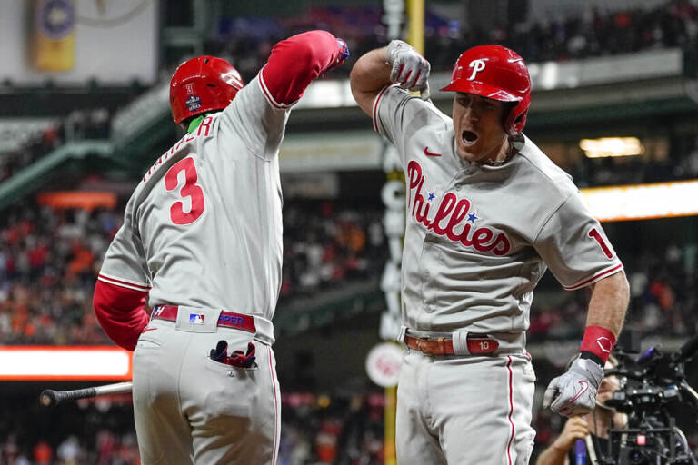 Two Phillies players do an elbow bump.