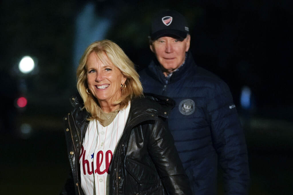 Joe Biden, Jill Biden File photo: First lady Jill Biden wears a Philadelphia Phillies jersey as she and President Joe Biden walk on the South Lawn of the White House after stepping off Marine One, Oct. 23, 2022, in Washington. (AP Photo/Patrick Semansky, File)