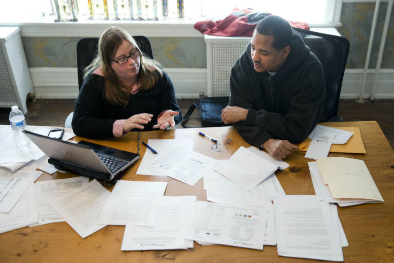 File photo; Erik Furness meets with Antoinette Kraus with the Pennsylvania Health Access Network to begin the process of signing up for insurance under the Affordable Care Act. (AP Photo/Matt Rourke)