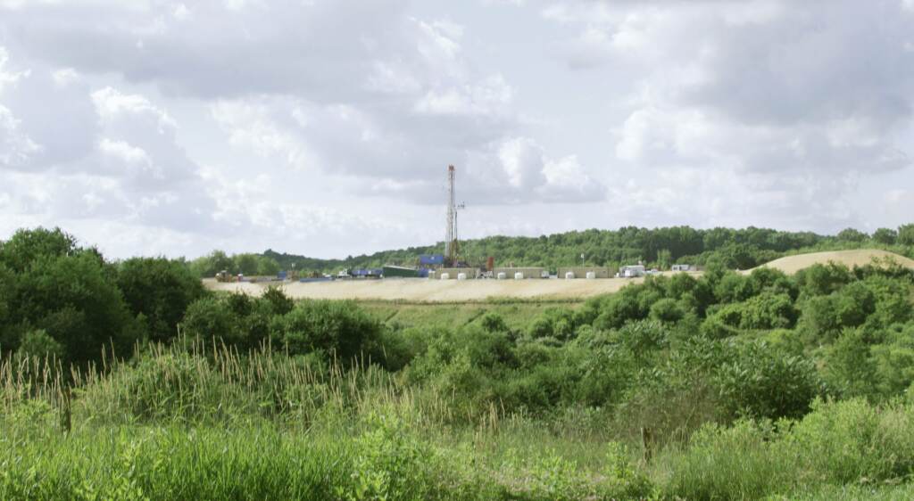 AP_120625025800-1920×1054 A green landscape is visible with a drilling rig in the background.