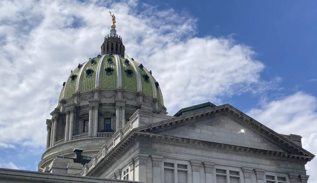 IMG_7296-1868×1080 The green dome of the Harrisburg State Capitol building is visible against a blue sky and clouds.