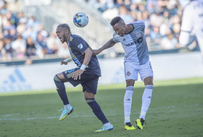 The Union's José Martínez left and Toronto's Mark-Anthony Kaye compete to head an incoming ball. (Jonathan Wilson/WHYY)