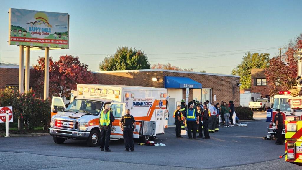 Child Care Center-Carbon Monoxide An ambulance is parked outside of a brick building.