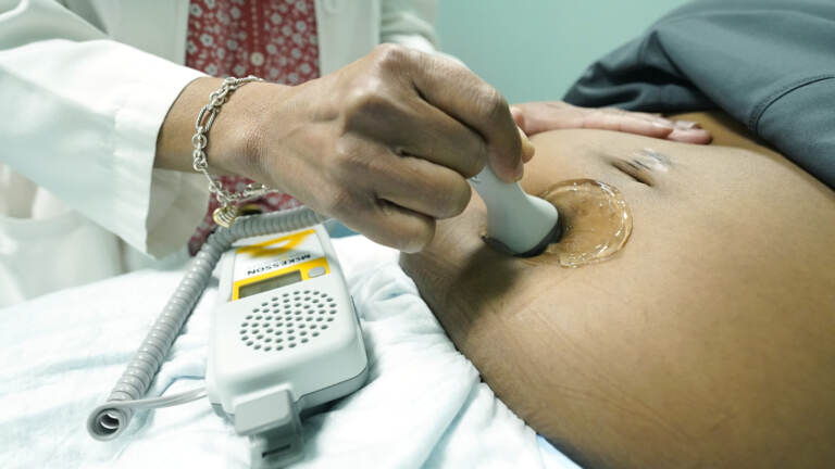 An up-close look at a midwife performing an ultrasound.