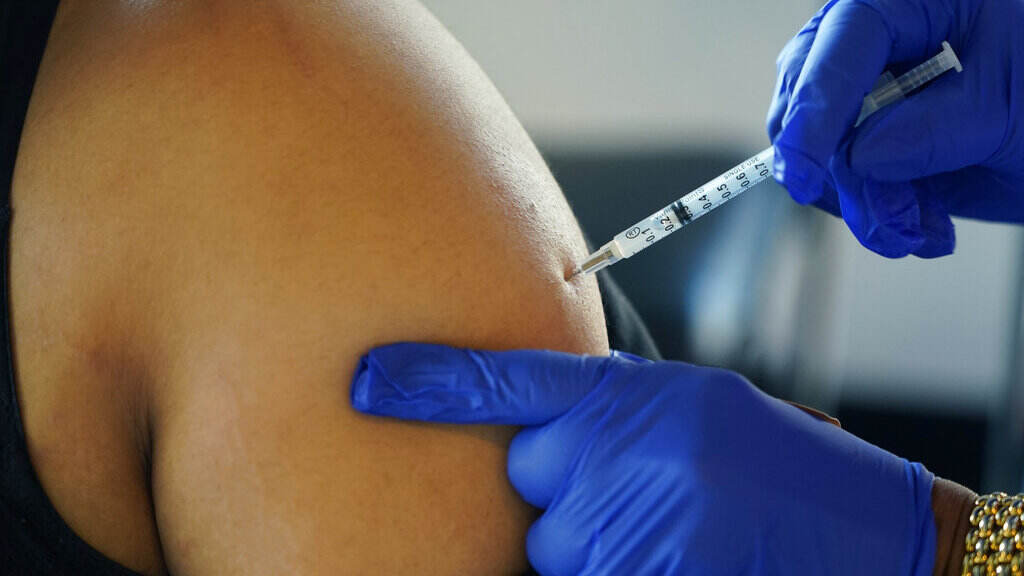 A Jackson, Miss., resident receives a Pfizer booster shot from a nurse at a vaccination site Feb. 8. A Jackson, Miss., resident receives a Pfizer booster shot from a nurse at a vaccination site Feb. 8. (Rogelio V. Solis/AP)