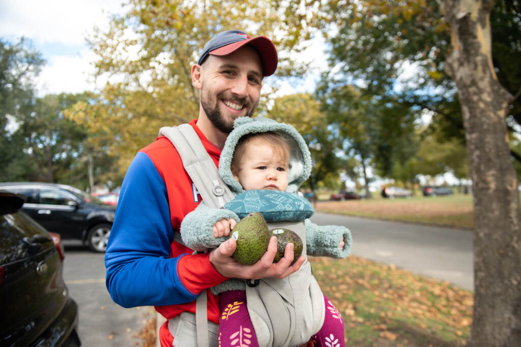 avogeddon-fdrpark-sharingexcess-avocados-07 Philly resident Jake Madeira and his 9-month-old daughter Marlowe pose with their free avocados
