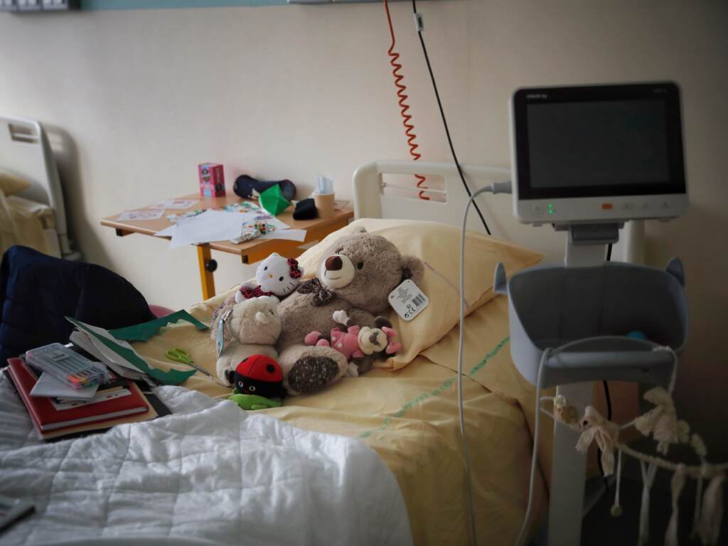 Sick kids are crowding emergency rooms in parts of the country. Several stuffed animals sit on a n empty hospital bed.