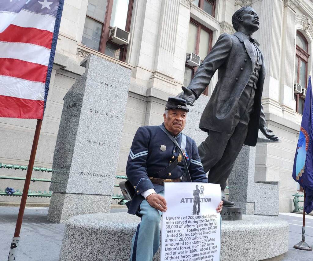 catto-city-2 Robert Fuller Houston of the 3rd Regiment sits by the Catto statue at City Hall on Oct. 10, 2022. (Tom MacDonald/WHYY)