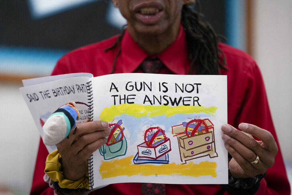 Children’s Books Gun Violence A person reads a children's book. The front reads,
