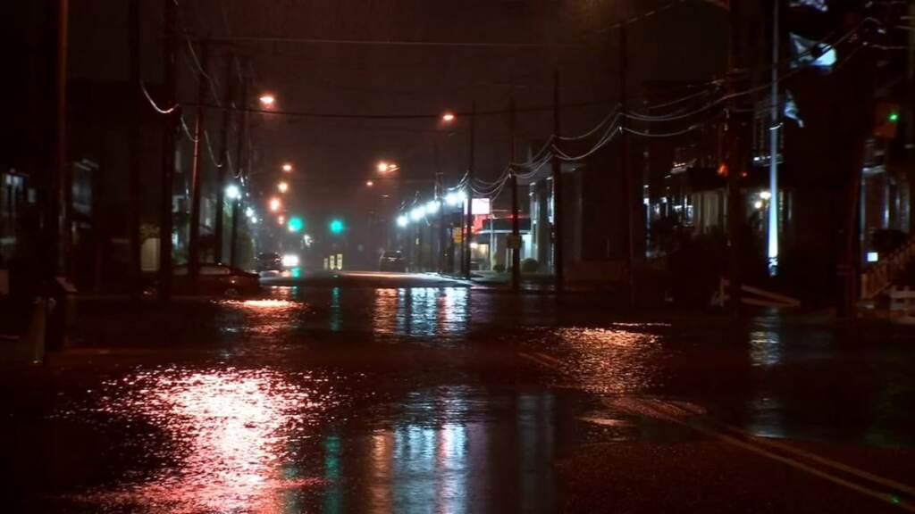 coastal-flooding-jersey-shore A flooded roadway is shown at night.