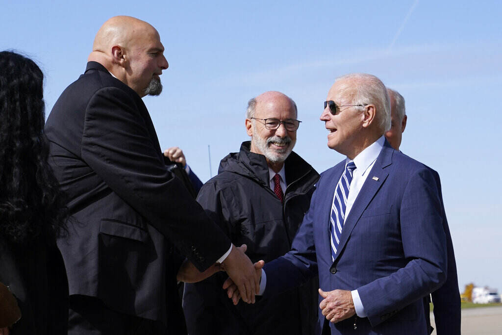 Joe Biden, John Fetterman Fetterman shakes Biden's hand.