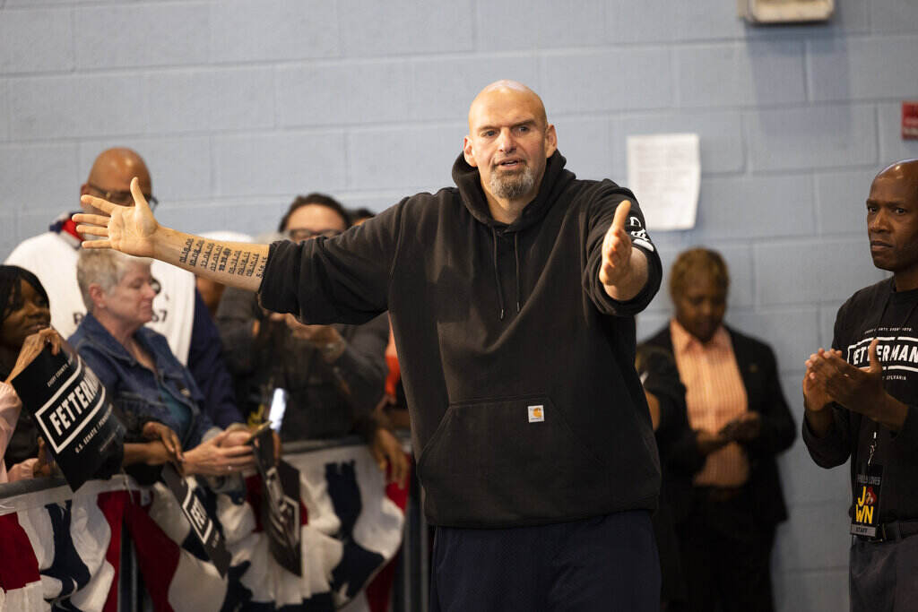 Election 2022-Pennsylvania-Black Voters John Fetterman gestures with his arms while speaking as people look on.