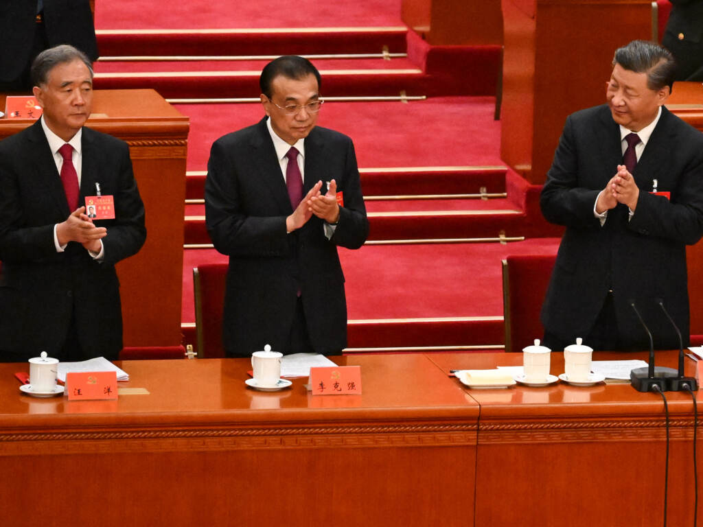 China's President Xi Jinping (right) applauds beside Premier Li Keqiang (center) and Politburo Standing Committee member Wang Yang during the closing ceremony of the 20th Chinese Communist Party's Congress in Beijing on Saturday. (Noel Celis/AFP via Getty Images)