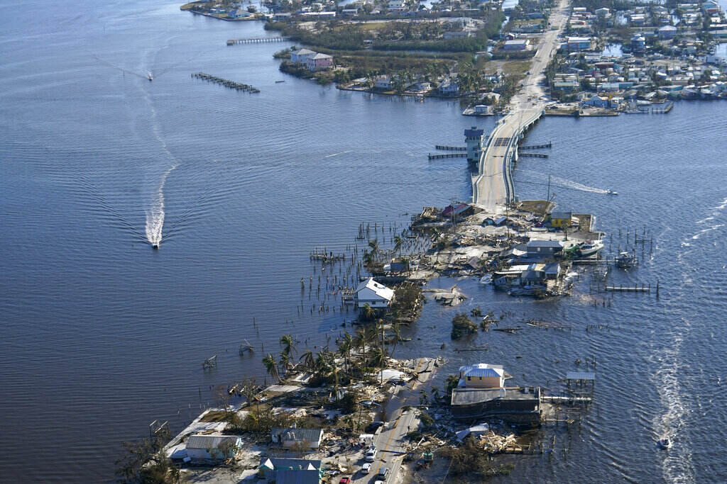 APTOPIX Tropical Weather Florida An aerial view shows a damaged bridge that has sunk into the water.