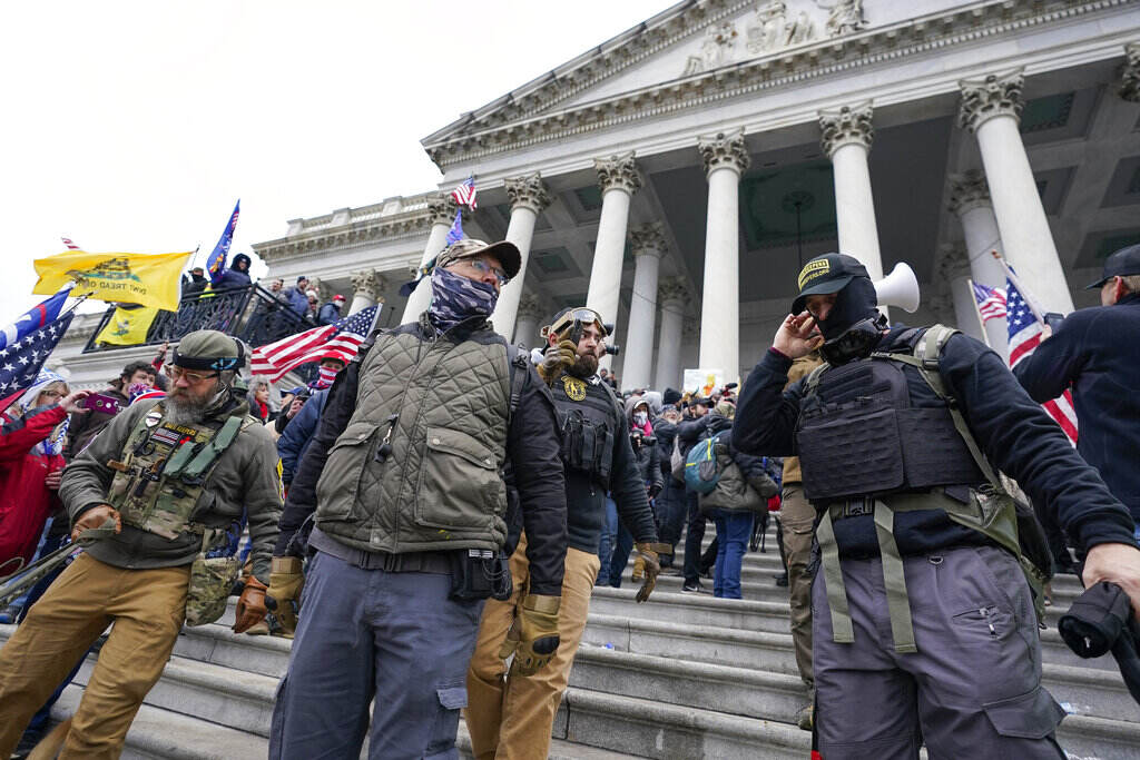Capitol Riot Oath Keepers People stand in front of the U.S. Capitol building during the Capitol riot on Jan. 6, 2021.