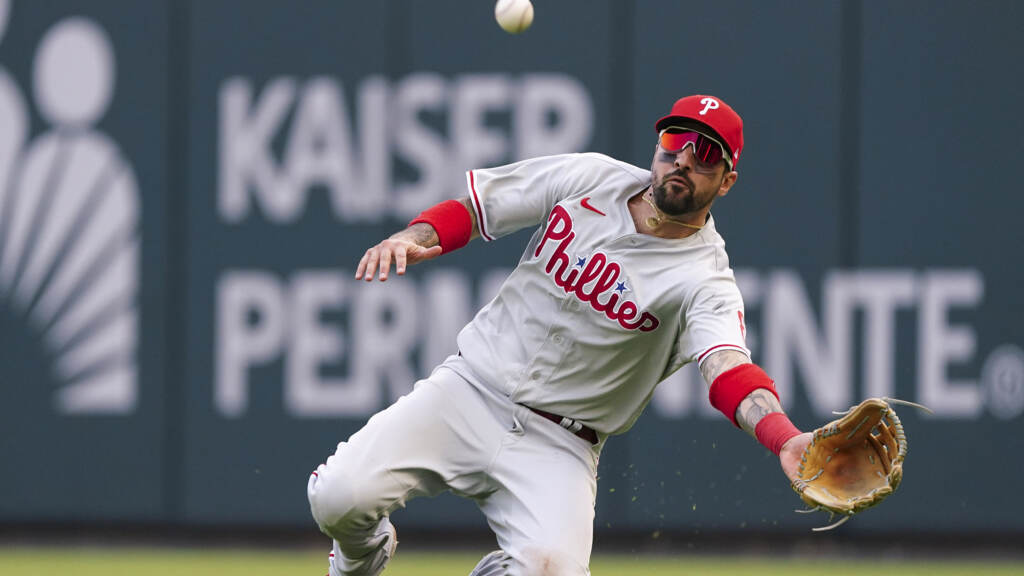 APTOPIX NLDS Phillies Braves Baseball Philadelphia Phillies right fielder Nick Castellanos (8) makes a diving catch against Atlanta Braves catcher William Contreras during the ninth inning in Game 1 of a National League Division Series baseball game, Tuesday, Oct. 11, 2022, in Atlanta. The Philadelphia Phillies won 7-6. (AP Photo/John Bazemore)