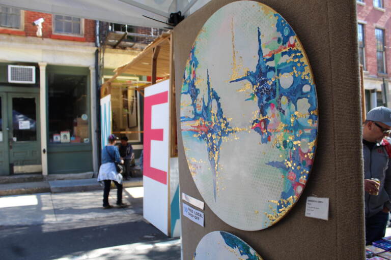 A close-up of an intricate painting on a circle.