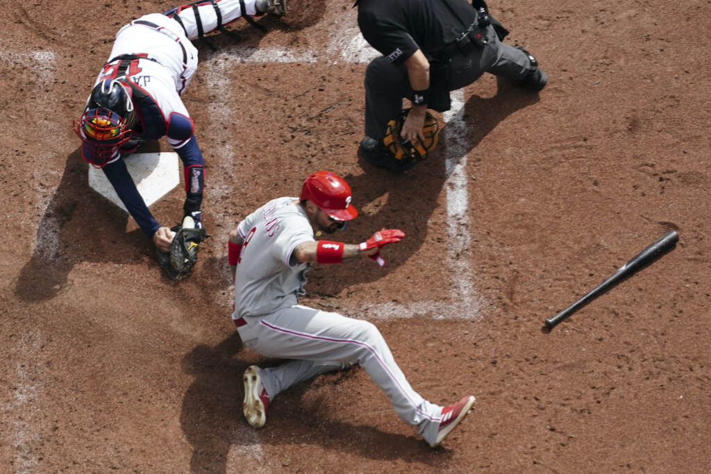 NLDS Phillies Braves Baseball Philadelphia Phillies right fielder Nick Castellanos (8) scores against Atlanta Braves catcher Travis d'Arnaud (16) during the third inning in Game 1 of a National League Division Series baseball game, Tuesday, Oct. 11, 2022, in Atlanta. (AP Photo/John Bazemore)