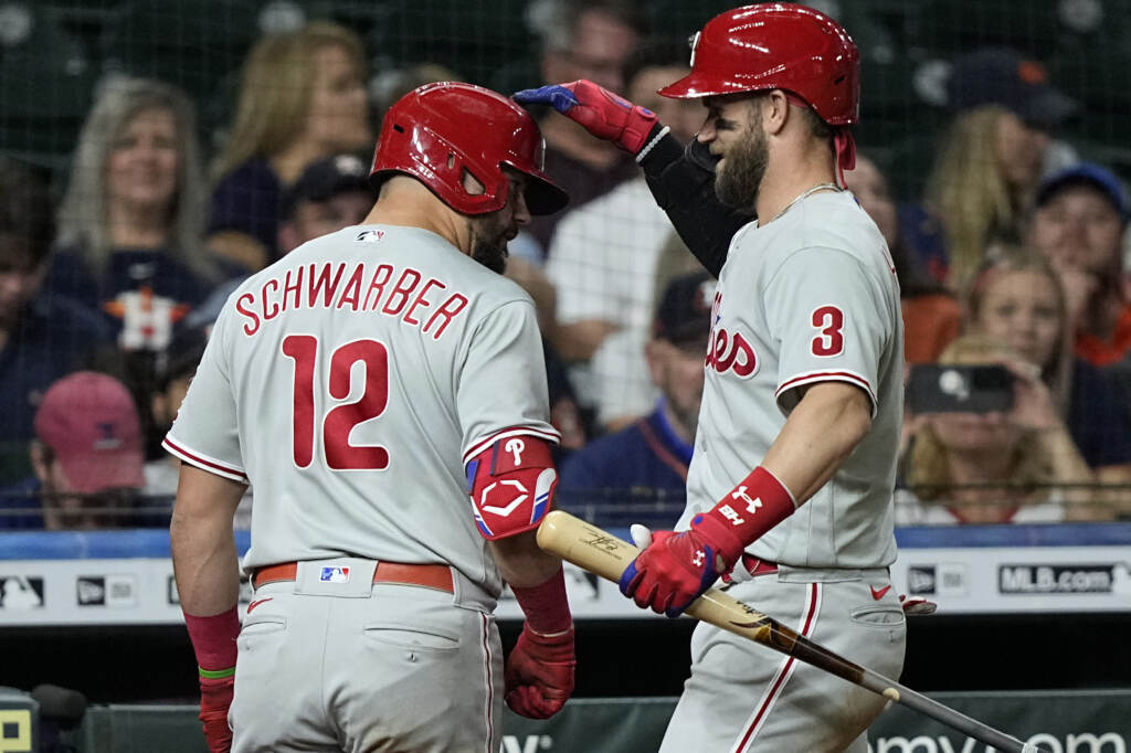 Phillies Astros Baseball Philadelphia Phillies' Kyle Schwarber (12) is congratulated by Bryce Harper (3) after hitting a home run against the Houston Astros during the eighth inning of a baseball game Monday, Oct. 3, 2022, in Houston. (AP Photo/David J. Phillip)