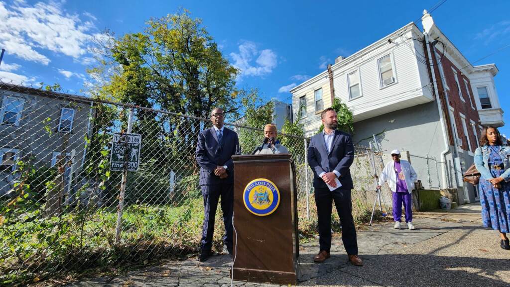 trees-weeds-tmacdonald-2022-10-13-2 Council President Darrell Clarke and Cindy Bass stand in front one of 'thousands of trees' Bass says will be removed by program. (Tom MacDonald/WHYY)