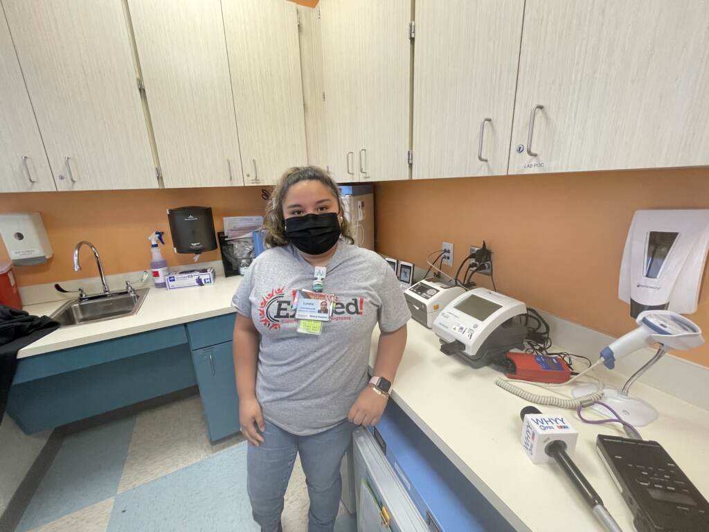 A nurse stands in a medical office.