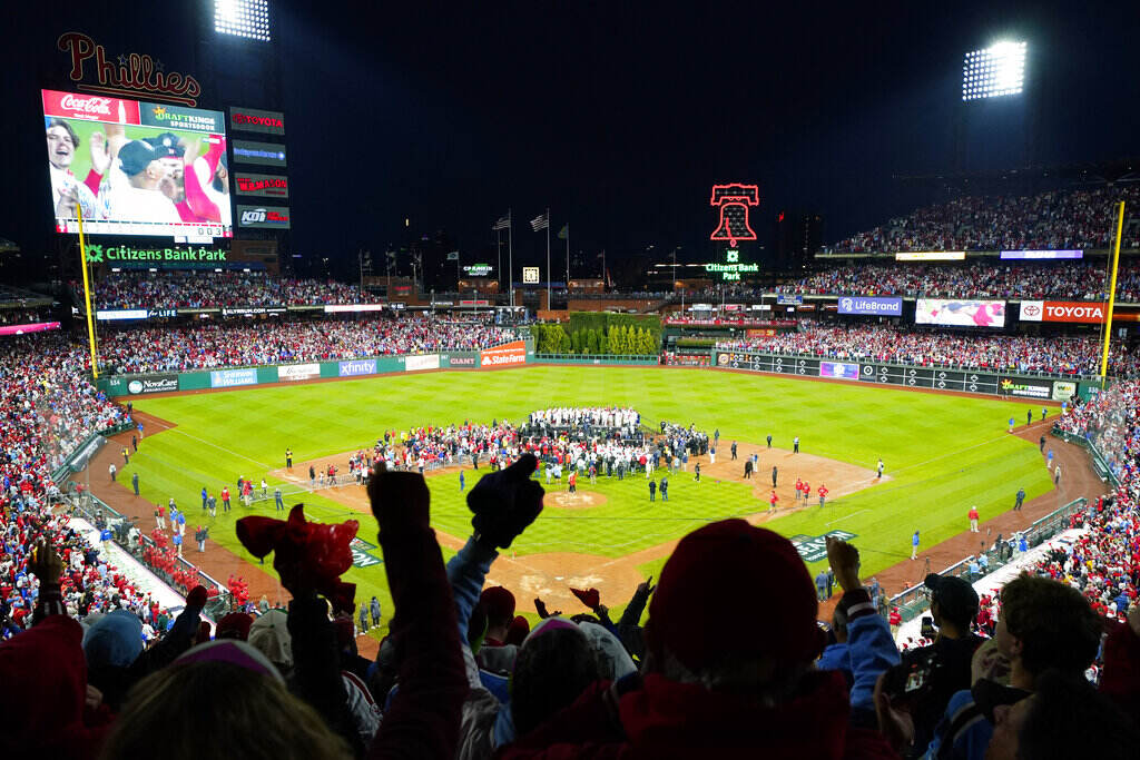 NLCS Padres Phillies Baseball A silhouette of fans cheering as the Phillies celebrate on the field at Citizens Bank Park.