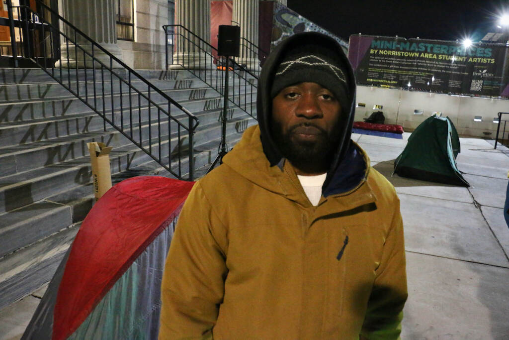 A man is dressed for cold weather.