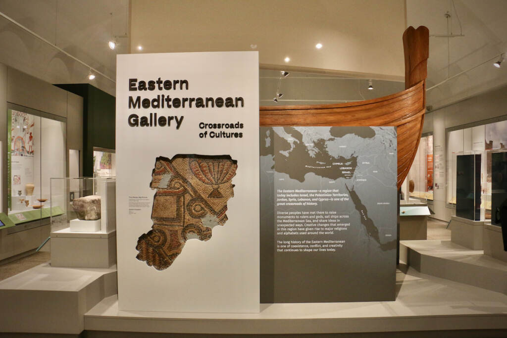 2022 11 17-e lee-philadelphia penn museum-new eastern mediterranean gallery entrance A sign reads Eastern Mediterranean Gallery in a large, open room.