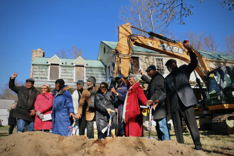 Members of the Board of the African American Museum of Bucks County celebrate at the groundbreaking for the museum at Boone Farm in Middletown Township. (Emma Lee/WHYY)