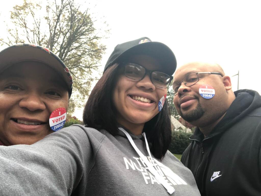 2022-vote-kamryn-davis-1 Three people smile and pose with